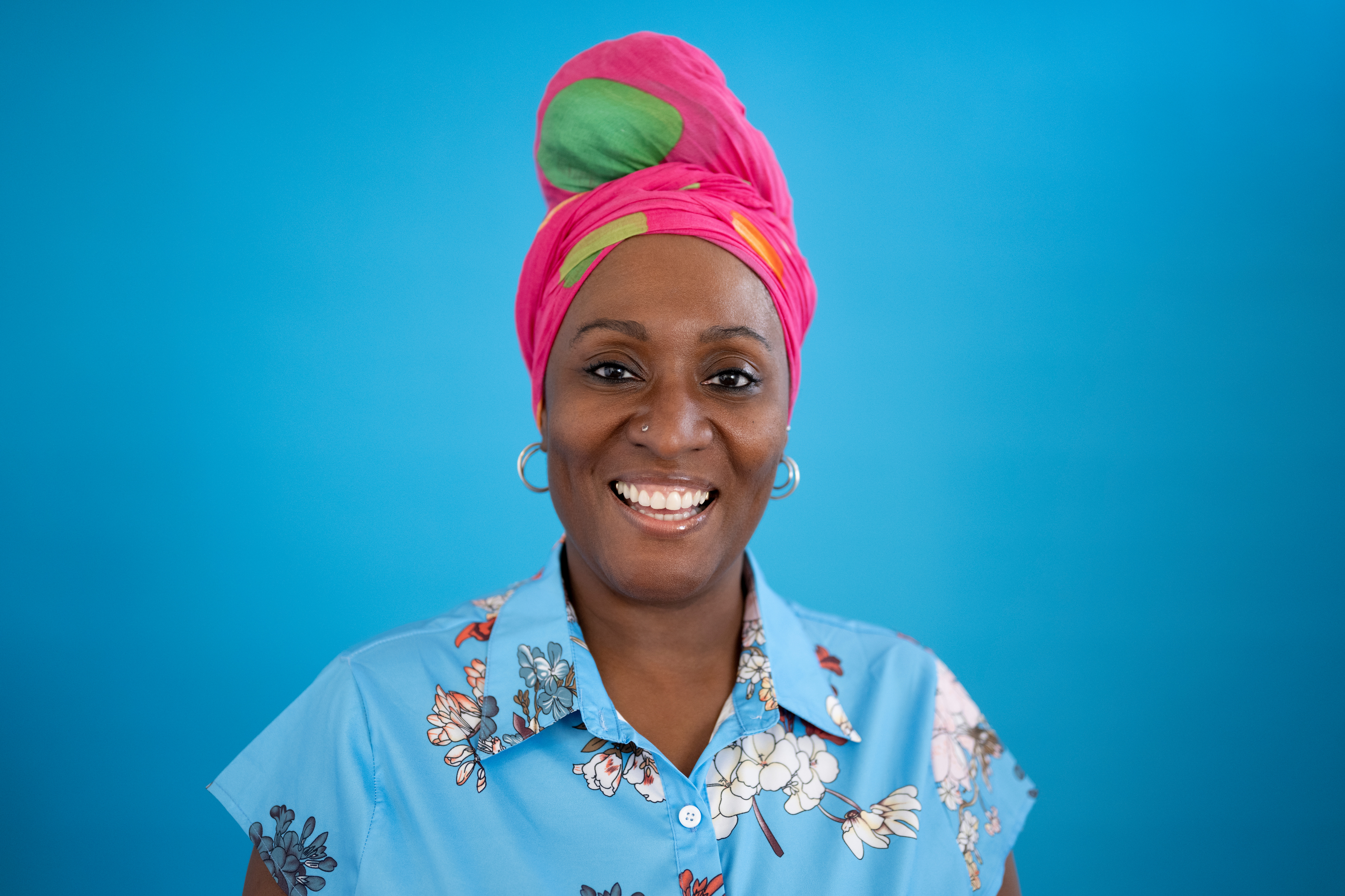 Close-up portrait of casual 48 year old black woman smiling at camera